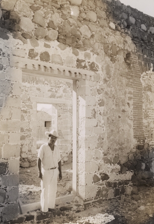 [Man standing in doorway of ruins, possibly Mission at Loreto, Baja California]