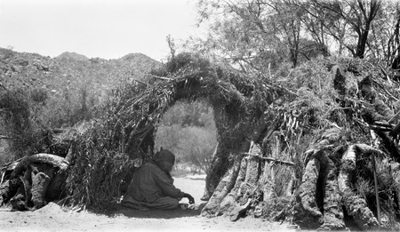 A Kiliwa house (wa&#39;), of the original primative type, made of weeds, boughs, and yucca trunks lashed to a framework of poles