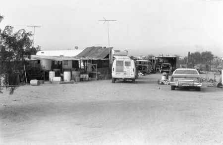 Slab City: photograph of desert housing and vehicles