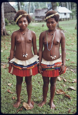 Adolescent girls wearing short fiber skirts, flower garlands, and mourning necklaces
