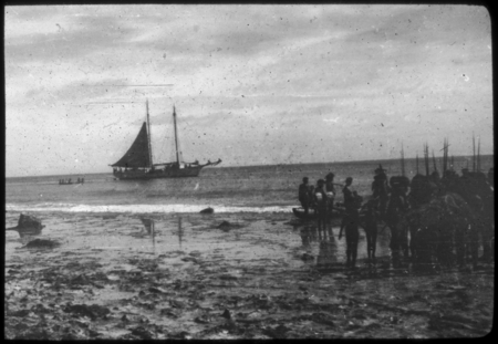 Group of natives by the shore; Zaca in the distance