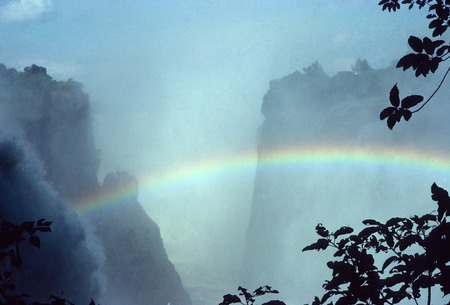 Mist rising from Victoria Falls, with rainbow