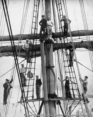 Sea scouts posing on main mast rigging of Star of India