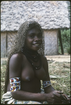 Semra&#39;s sister wearing beaded armbands and necklace, looped cape
