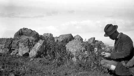 Fred Kneffin writing notes at rock feature