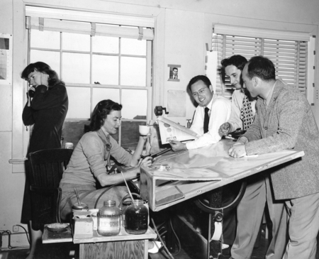 University of California Division of War Research (UCDWR) Training Aid unit staff around drafting table