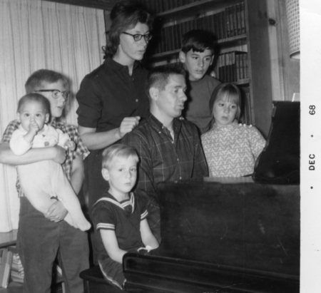 Charles D. Keeling family around the piano (left to right: baby Paul, Ralph, Eric (seated), Louise and Charles D., Andrew ...