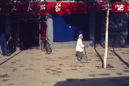 Old Woman on Urban Sidewalk