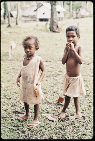 Young children, Imala (l) with another girl, both wear shell necklaces