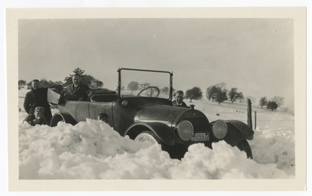 Automobile surrounded by snow banks in Cuyamaca