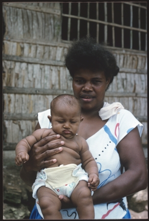 Woman and infant at Gounaabusu, South Sea Evangelical Church village at Sinalagu Harbour.