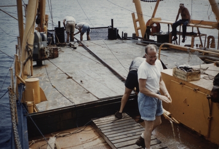 Russell W. Raitt in foreground, Chief Engineer Gene Trease sitting on rail. onboard Spencer F. Baird, Downwind Expedition....