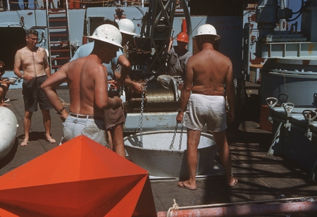 Members of Swan Song Expedition (1961) crew are shown here assembling the taunt wire buoy launch, placing the chain in the...