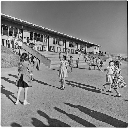 Children playing outside at Alessio School Number 4, Colonia Postal