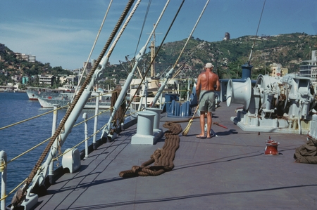 During the Swan Song Expedition (1961) a member of the ship&#39;s crew is photographed sweeping the deck while the scientific ...