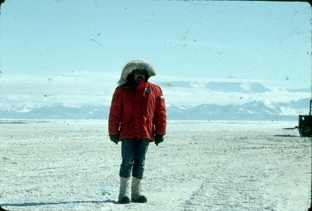 James Ronald Stewart, on the sea ice, with Trans-Antarctic Mountains in the background. McMurdo Station, Antarctica