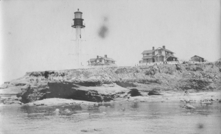 The Point Loma lighthouse and caretakers houses when men were gathered at the lighthouse to salvage the wreck of the &quot;Loma...