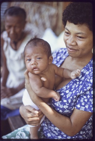 Woman holding a young infant