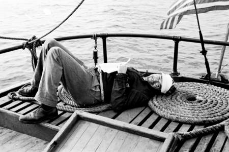 David Quentin Anderson lying down on the deck of a boat