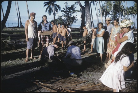 Local people watching archaeological excavation on Moorea, Ann Rappaport with box