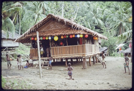 House decorated with balloons, children playing