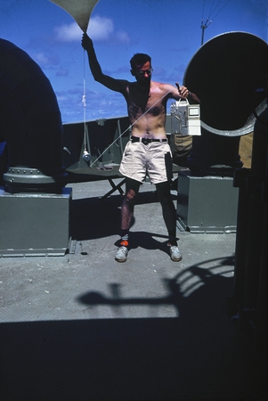 Stanley Rittenberg launching weather balloon during the Capricorn Expedition (1952-1953). This expedition mapped seamounts...