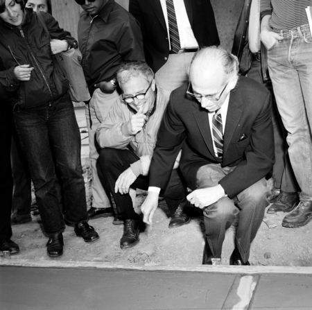 John Stewart and Jonas Salk signing their names in cement, Muir College, UC San Diego
