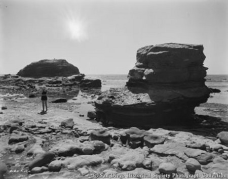 Woman standing on beach at Bird Rock, La Jolla