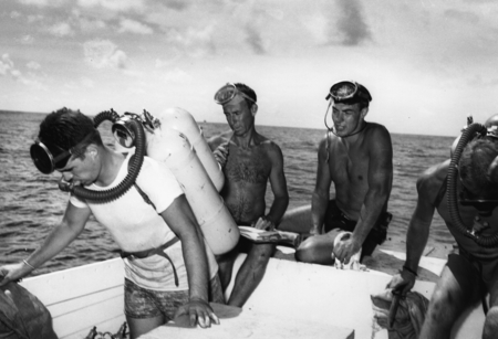 Divers, including Walter Munk (left center) and Robert Livingston (right center), work from a motor launch at Alexa Bank, ...