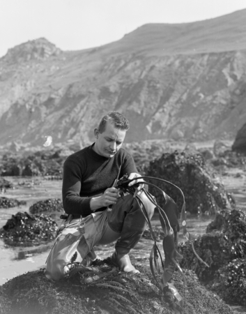 Robert Menzies of the College of the Pacific Mar Station in a Laminaua Zone (low tide) collecting Isopods, at Dillons Beac...