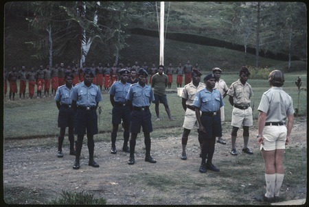 Police, and other government employees in uniform, lined up in front of patrol officer, Tabibuga