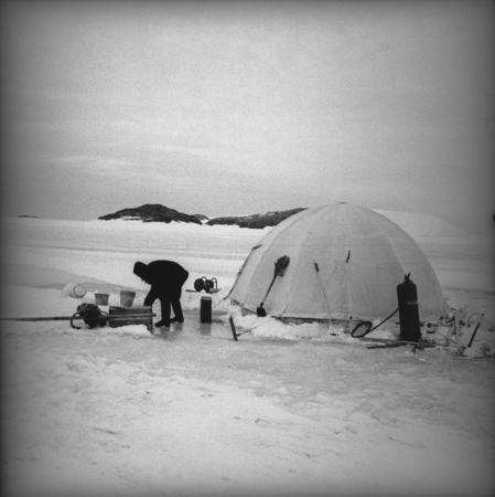 Preparations around polar tent by diver