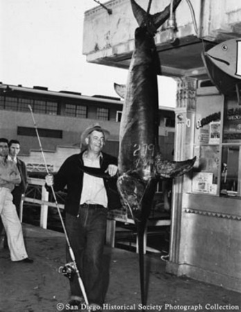 Roy O. Hoover posing with swordfish catch at H &amp; M Sport Fishing Company