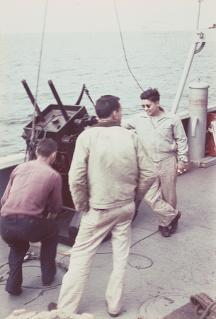 Microbiologist Richard Y. Morita (shown here facing camera), is seen here along with two unidentified men on the deck the ...