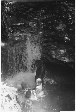 People, including Keesing&#39;s daughters, in pool of water, waterfall.