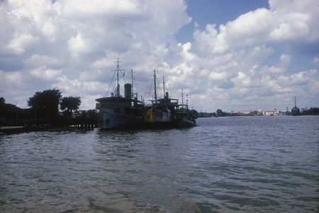 Fishing boat landing - Thai Navy Yard in Background