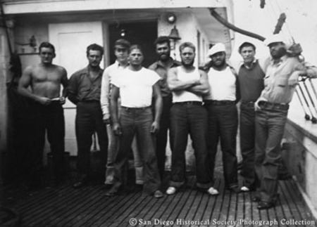 Group portrait of Italian fishermen on deck of tuna boat