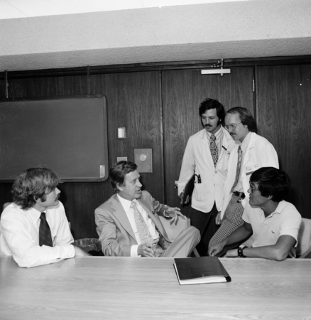Robert N. Hamberger (center) talking with medical students