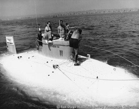Three men topside on Lockheed&#39;s Deep Quest submarine