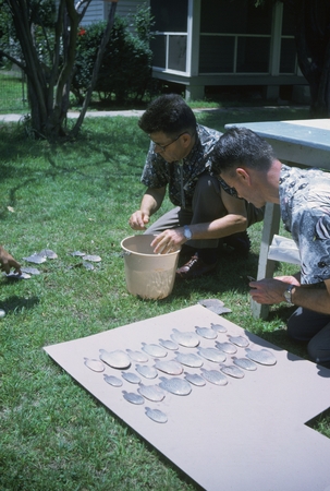 Carl L. Hubbs and unidentified man sorting Trinectes maculatus specimens, Patuxent River, Maryland
