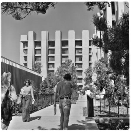 Students walking with the Applied Physics and Mathematics Building in background