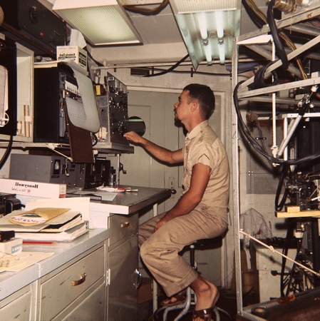 Unidentified scientist is shown here on watch on the research ship Argo during the Lusiad Expedition (1962-63). This exped...