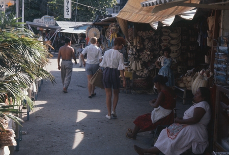 During a break from the Swan Song Expedition (1961) a member of the crew took this photo of a market street scene in Acapu...