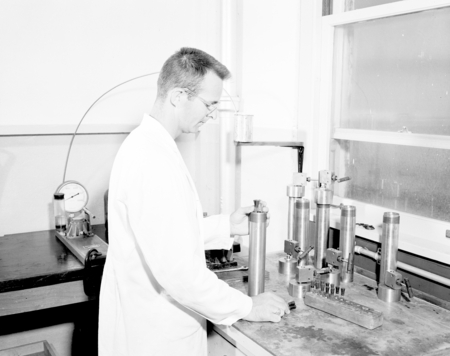 Carl Oppenheimer placing bacterial cultures in hydrostatic pressure receptacle