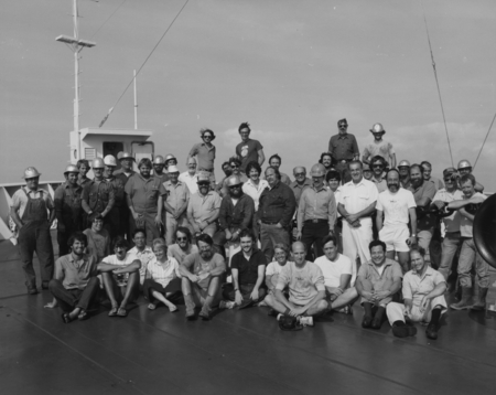 Scientists and technicians of Deep Sea Drilling Project, Leg 76, on D/V Glomar Challenger (ship) foredeck. 1980.