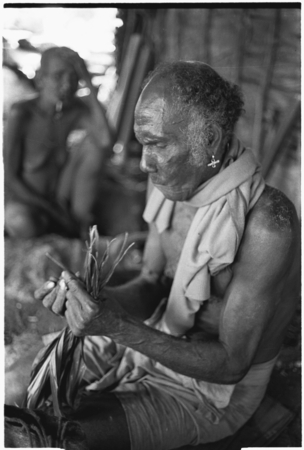 Folofo&#39;u performing divination with cordyline leaves.