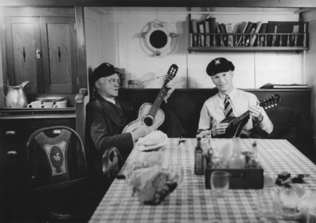 Loye Holmes Miller and Martin Wiggo Johnson playing guitar and mandolin in the galley of R/V E.W. Scripps