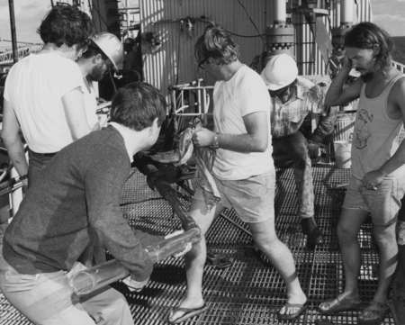 Crew members of the D/V Glomar Challenger (ship) who were inserting a heat flow tool into the core barrel for deployment i...