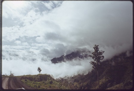Highlands Highway between Lae and Mount Hagen: road disappearing into cloud, mountains