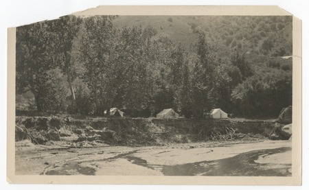 Camping tents near an unidentified river